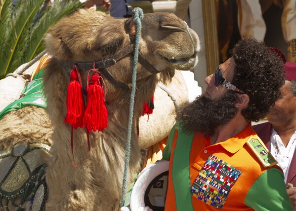 Actor Sacha Baron Cohen poses with a a camel during a photo call for The Dictator at the 65th international film festival, in Cannes, southern France, Wednesday, May 16, 2012. (AP Photo/Joel Ryan, File)