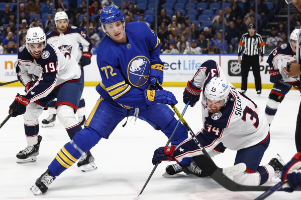 FILE - Buffalo Sabres center Tage Thompson (72) and Columbus Blue Jackets center Cole Sillinger (34) compete during a faceoff during the first period of an NHL hockey game Feb. 28, 2023, in Buffalo, N.Y. Thompson finished sixth in the NHL with 47 goals last season, while Rasmus Dahlin finished fifth among NHL defensemen with 73 points. (AP Photo/Jeffrey T. Barnes, File)