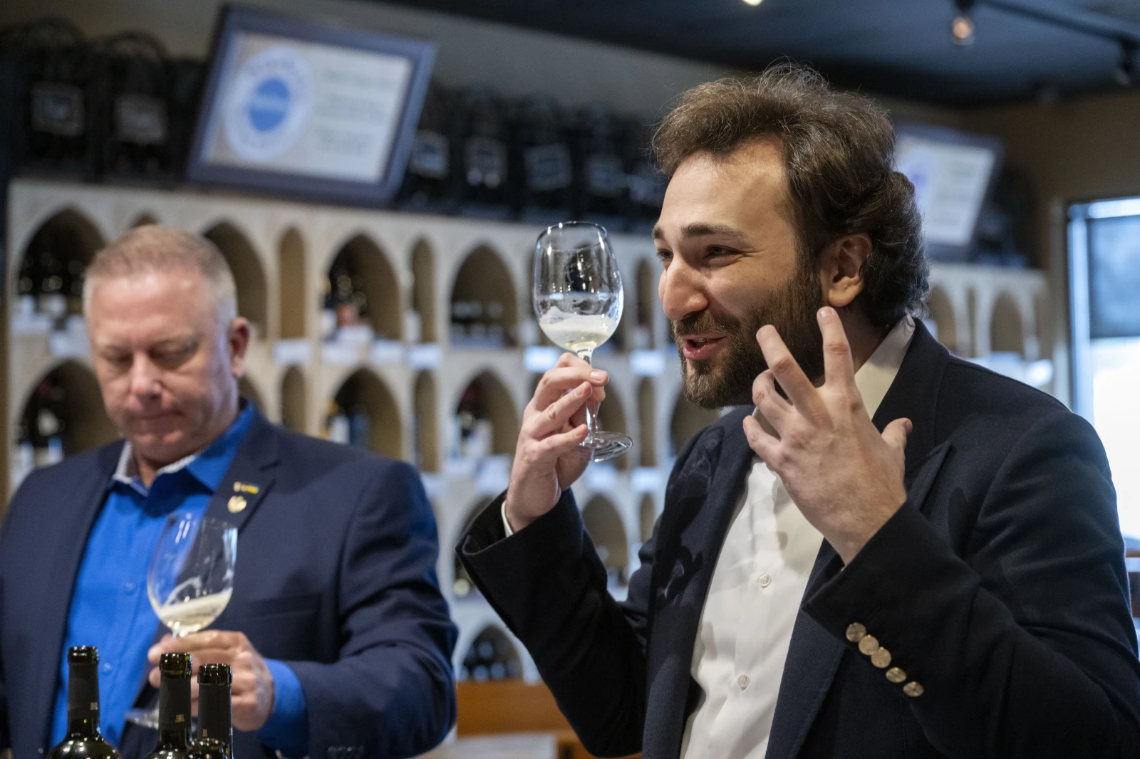 Interior of WineStyles wine store, Giorgi Lukuridze, owner and CEO Shabo, a Ukrainian winery (right) describes his wine during a tasting with Joseph Belli, Sales Manager for SPYRT Worldwide, at WineStyles in Dumfries, Virginia (AP Photo/Kevin Wolf)