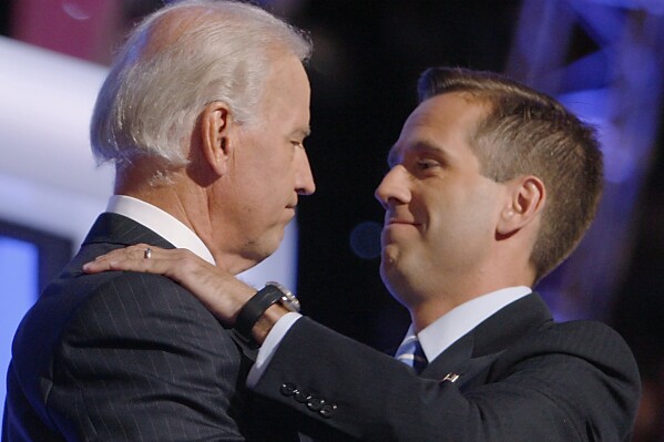 FILE - Then-Democratic vice presidential candidate Sen. Joe Biden, D-Del., left, embraces his son Beau Biden on stage at the Democratic National Convention in Denver, Aug. 27, 2008. (AP Photo/Charles Dharapak, File)