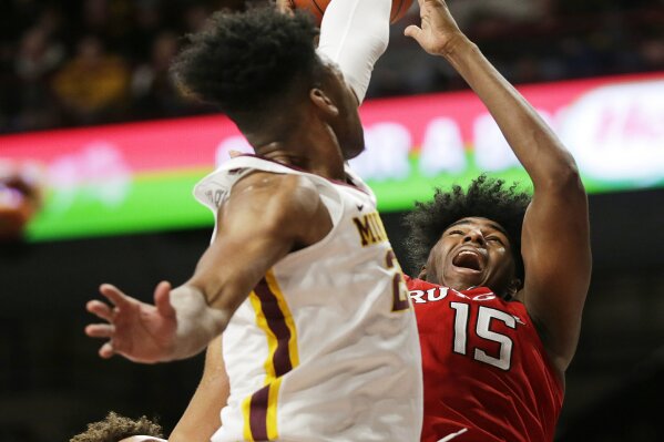 
              Rutgers center Myles Johnson (15) shoots over Minnesota guard Marcus Carr (2) during the second half of an NCAA college basketball game Saturday, Jan. 12, 2019, in Minneapolis. Minnesota defeated Rutgers 88-70. (AP Photo/Andy Clayton-King)
            
