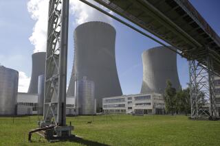 FILE - Smoke rises from cooling towers of the nuclear power plant Temelin near the town of Tyn nad Vltavou, Czech Republic, June 25, 2015. The American Westinghouse and France’s Framatome have won a tender to deliver fuel supplies for the Temelin nuclear plant in the Czech Republic, easing the country’s dependence on Russia, it was announced Tuesday, April 12, 2022. State-controlled power company CEZ says that Westinghouse and Framatome will deliver the nuclear fuel for some 15 years, starting in 2024. (AP Photo/Petr David Josek, file)