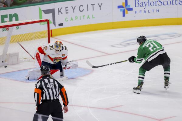 Dallas Stars left wing Jason Robertson (21) scores past Florida Panthers goalie Spencer Knight (30) in the third period of an NHL hockey game in Dallas, Sunday, Jan. 8, 2023. (AP Photo/Gareth Patterson)