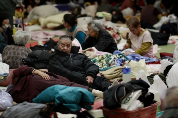 FILE - In this March 14, 2011, file photo, evacuees rest in a shelter in Soma city, Fukushima prefecture, Japan, three days after a massive earthquake and tsunami struck the country's north east coast. A hydrogen explosion occurs at the Fukushima Daiichi nuclear plant’s No. 1 reactor, sending radiation into the air. Residents within a 20-kilometer (12-mile) radius are ordered to evacuate. Similar explosions occur at two other reactors over the following days. (AP Photo/Wally Santana, File)