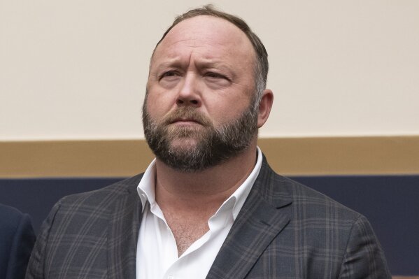 FILE - This Tuesday, Dec. 11, 2018 file photo shows radio show host and conspiracy theorist Alex Jones at Capitol Hill in Washington. On Thursday, April 9, 2020, the U.S. Food and Drug Administration sent a warning letter ordering Jones to stop falsely claiming that toothpaste, mouth wash and other products sponsored by his show can help prevent COVID-19. (AP Photo/J. Scott Applewhite)