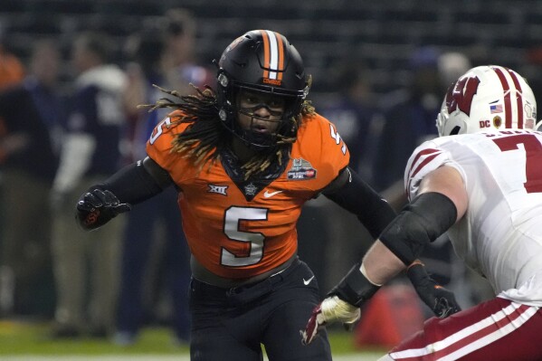 FILE - klahoma State safety Kendal Daniels (5) during the second half of the Guaranteed Rate Bowl NCAA college football game against Wisconsin Tuesday, Dec. 27, 2022, in Phoenix. Oklahoma State opens their season at home against Central Arkansas. (AP Photo/Rick Scuteri, File)