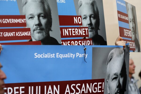 
              Protestors brandish posters depicting Julian Assange as they demonstrate at the entrance of Westminster Magistrates Court in London, Thursday, May 2, 2019, where WikiLeaks founder Assange is expected to appear by video link from prison.  Assange is facing a court hearing over a U.S. request to extradite him for alleged computer hacking.(AP Photo/Frank Augstein)
            
