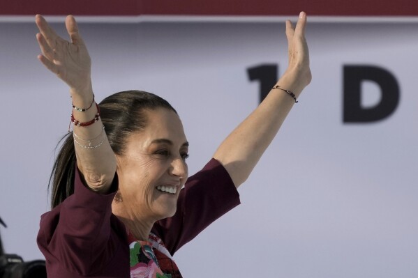 FILE - Presidential candidate Claudia Sheinbaum waves during her opening campaign rally at the Zocalo in Mexico City, March 1, 2024. Sheinbaum, the ruling party candidate in the June 2 elections, vows to stick to President Andres Manuel Lopez Obrador's approach on public safety. (AP Photo/Marco Ugarte, File)