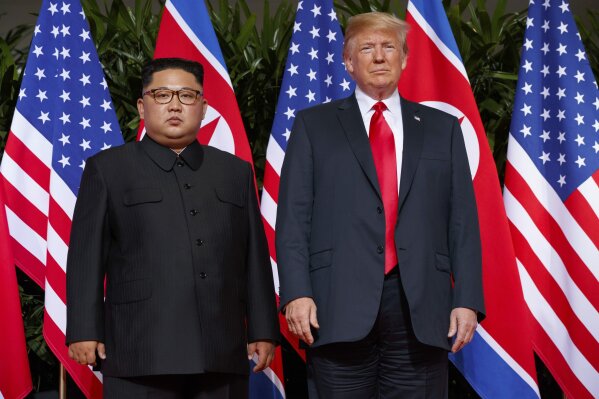 
              FILE - In this June. 12, 2018, file photo, U.S. President Donald Trump, right, meets with North Korean leader Kim Jong Un on Sentosa Island, in Singapore. North Korea says it will never unilaterally give up its nuclear weapons unless the United States removes its nuclear threat first. The statement carried by the official Korean Central News Agency on Thursday, Dec. 20, 2018,  comes amid a deadlock in nuclear negotiations between the United States and North Korea. It raises further doubts on whether leader Kim Jong Un will ever relinquish an arsenal he may see as his greatest guarantee of survival. (AP Photo/Evan Vucci, File)
            