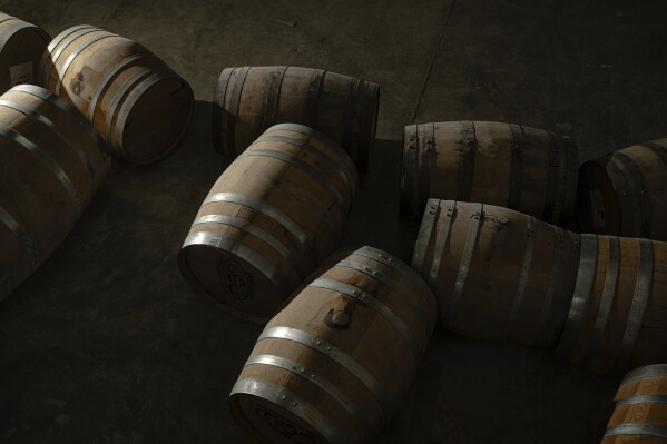 Bourbon barrels with product in them are seen inside of the Brough Brothers Distillery in Louisville, Ky., Saturday, March 8, 2025. (AP Photo/Jon Cherry)