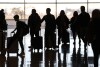 FILE - People pass through Salt Lake City International Airport on Wednesday, Jan. 11, 2023, in Salt Lake City. Thirty percent of Americans don't identify with a religious group — but not all of them are atheists or agnostics. In fact, 43% of the group known as the "nones" say they believe in God, even if they largely dislike organized religion. (AP Photo/Rick Bowmer, File)
