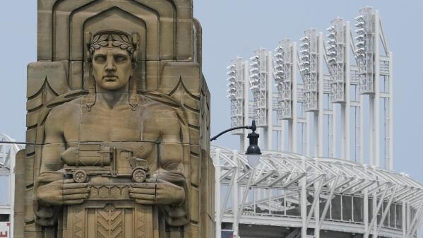 A guardian rests on the Hope Memorial Bridge within site of Progressive Field, Friday, July 23, 2021, in Cleveland. Cleveland's new name was inspired by two large landmark stone edifices near the downtown ballpark, referred to as traffic guardians, on the Hope Memorial Bridge over the Cuyahoga River. The team's colors will remain the same, and the new Guardians' new logos will incorporate some of the architectural features of the bridge. (AP Photo/Tony Dejak)
