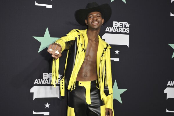 FILE - In a Sunday, June 23, 2019 file photo, Lil Nas X poses in the press room at the BET Awards, at the Microsoft Theater in Los Angeles. Lil Nas X has set two new records on Billboard's Hot R&B/Hip-Hop songs and Hot rap songs charts. "Old Town Road," which is spending its 19th week at No. 1, surpasses the record set by Drake's "One Dance" on the R&B/Hip-Hop songs chart.(Photo by Richard Shotwell/Invision/AP, File)