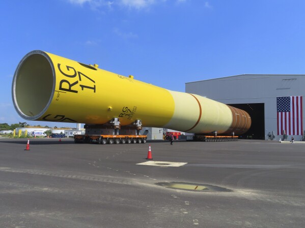 A giant monopile, the foundation for an offshore wind turbine, sits on rollers at the Paulsboro Marine Terminal in Paulsboro, N.J. on Thursday, July 6, 2023, when New Jersey Gov. Phil Murphy planned to sign a bill granting a tax break to offshore wind developer Orsted. (AP Photo/Wayne Parry)