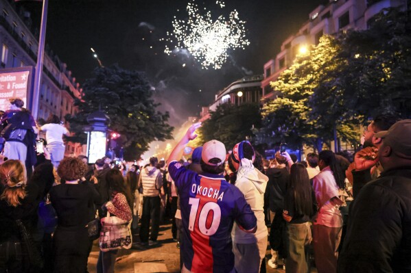 Paris Saint-Germain fans celebrate after the Champions League semifinal, second leg soccer match between PSG and Arsenal on the Champs-Elysees avenue in Paris, Wednesday, May 7, 2025. (AP Photo/Thomas Padilla)