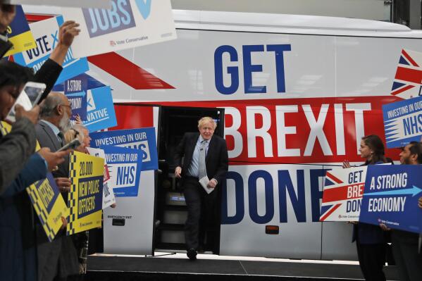 FILE - Britain's Prime Minister Boris Johnson addresses his supporters prior to boarding his General Election campaign trail bus in Manchester, England, Friday, Nov. 15, 2019. The moving vans have already started arriving in Downing Street, as Britain's Conservative Party prepares to evict Johnson. Debate about what mark he will leave on his party, his country and the world will linger long after he departs in September. (AP Photo/Frank Augstein, Pool, File)