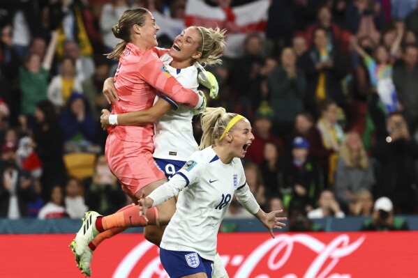 England's Chloe Kelly, right, celebrates after scoring the last goal during a penalty shootout at the Women's World Cup round of 16 soccer match against Nigeria in Brisbane, Australia, Monday, Aug. 7, 2023. (AP Photo/Tertius Pickard)