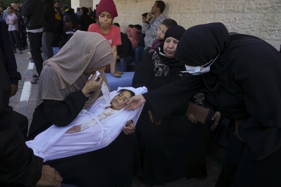 A mother cries for her daughter who was killed in the Israeli bombardment of the Gaza Strip al in Deir al Balah on Sunday, Dec. 3, 2023. (AP Photo/ Hatem Moussa)