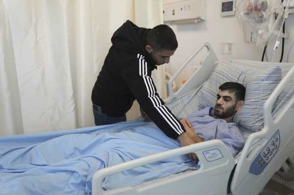 Nader Rimawi recovers in a Ramallah hospital on Sunday, Jan. 7, 2024, after he was wounded by Israeli forces in a shooting last week in the occupied West Bank village of Beit Rima that also injured his brother and killed a 17-year-old. An Associated Press review of security camera footage and interviews with the two wounded survivors indicate that Israeli soldiers opened fire on the trio when they did not appear to pose a threat. (AP Photo/Mahmoud Illean)