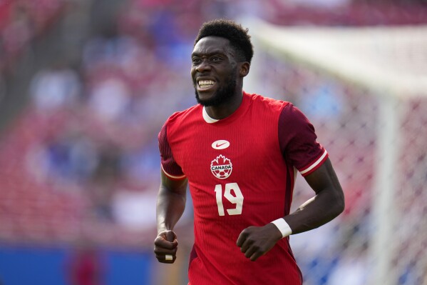 Canada forward Alphonso Davies (19) jogs up field after taking a shot in the second half of a CONCACAF Nations League Play-In soccer match against Trinidad And Tobago, Saturday, March 23, 2024, in Frisco, Texas. (AP Photo/Julio Cortez)