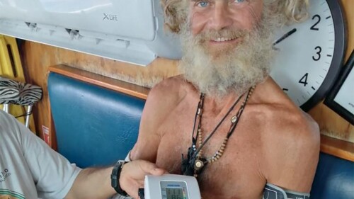 In this photo provided by Grupomar/Atun Tuny, Australian Tim Shaddock has his blood pressure taken after being rescued by a Mexican tuna vessel in international waters in the Pacific, after he drifted with his dog for three months.  (Grupomar/Atun Tuny via AP)