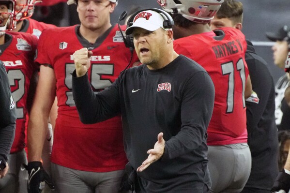 FILE - UNLV head coach Barry Odom reacts to his defense during the second half of the Guaranteed Rate Bowl NCAA college football game against Kansas Tuesday, Dec. 26, 2023, in Phoenix. UNLV signed football coach Barry Odom to a new contract that takes him to the 2018 season, Friday, April 12, 2024. The Rebels went 9-5 last season, their most victories since 1984. (AP Photo/Rick Scuteri, File)