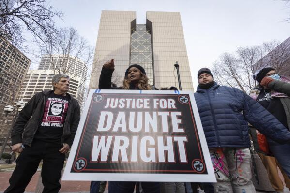 Activists hold a press conference alongside the family of Daunte Wright outside the Hennepin County Courthouse during the trial of former Brooklyn Center police Officer Kim Potter, Friday Dec. 17, 2021, in Minneapolis. Potter, who is white, is charged with first- and second-degree manslaughter in the shooting of Daunte Wright, a Black motorist, in the suburb of Brooklyn Center. Potter has said she meant to use her Taser – but grabbed her handgun instead – after Wright tried to drive away as officers were trying to arrest him. (AP Photo/Christian Monterrosa)