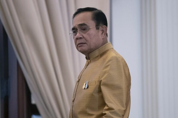 Thailand's Prime Minister Prayuth Chan-ocha leaves after a press conference at Government House in Bangkok, Thailand, Tuesday, Dec. 1, 2020. Thailand’s highest court Wednesday acquitted Prayuth of breaching ethics clauses in the country’s constitution, allowing him to stay in his job. (AP Photo/Sakchai Lalit)