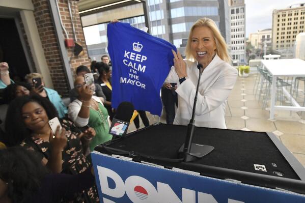 Donna Deegan holds up a T-shirt her daughter bought for her on a trip to London, while speaking with supporters in her run for mayor of Jacksonville, Fla., Tuesday, May 16, 2023. Deegan defeated Republican Daniel Davis, becoming the first female to be elected as the city's mayor. (Bob Self/The Florida Times-Union via AP)