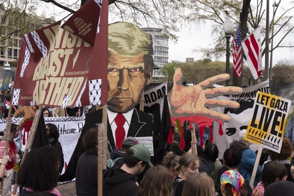 Pro-Palestinian protesters carrying a depiction of President Donald Trump gather at a rally before marching toward the U.S. Immigration and Customs Enforcement (ICE) headquarters, Saturday, April 5, 2025, in Washington. (AP Photo/Manuel Balce Ceneta)