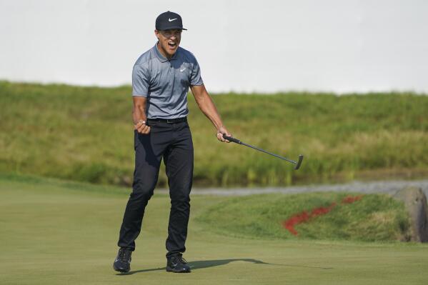 Cameron Champ celebrates after sinking a putt on the 18th hole to win the 3M Open golf tournament in Blaine, Minn., Sunday, July 25, 2021. (AP Photo/Craig Lassig)