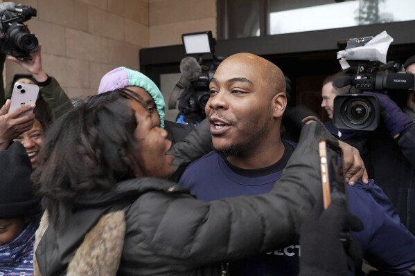 Marvin Haynes, 35, is hugged by a supporter as he walks out of the Minnesota Correctional Facility at Stillwater in Bayport, Minn. on Monday, Dec. 11, 2023, after a judge set aside his murder conviction in the 2004 killing of a man at a Minneapolis flower shop. Haynes was 16 when Randy Sherer, 55, was killed during a robbery. (AP Photo/Mark Vancleave)