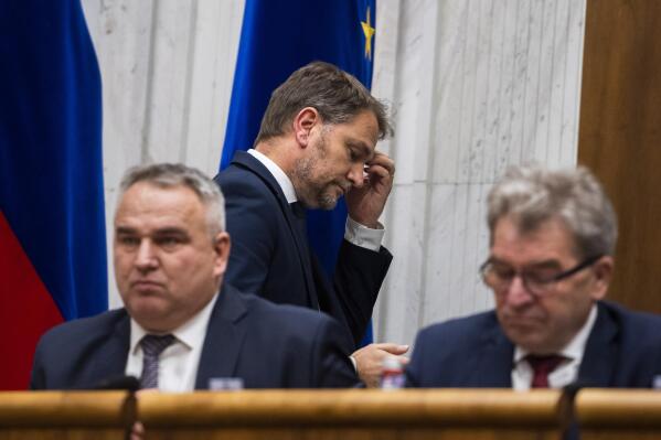 Slovakia's Finance Minister Igor Matovic, centre, leaves the hall ahead of a confidence vote for his Cabinet at the parliament session in Bratislava, Thursday, Dec. 15, 2022. Slovakia’s coalition government has fallen after losing a parliamentary no-confidence vote Thursday, a move that could lead to an early election. (Jaroslav Novak/TASR via AP)