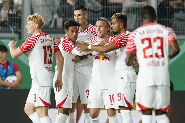 Leipzig's scorer Emil Forsberg, third right, and his teammates celebrate the opening goal during the German soccer cup first round match between SV Wehen Wiesbaden and RB Leipzig in Wiesbaden, Germany, Wednesday, Sept. 27, 2023. (Uwe Anspach/dpa via AP)