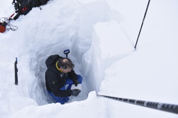 Doug Chabot, with the Gallatin National Forest Avalanche Center, measures the stability of the snow near Lulu Pass in the Beartooth Mountains, Jan 29, 2024, near Cooke City, Mont.(AP Photo/Matthew Brown)
