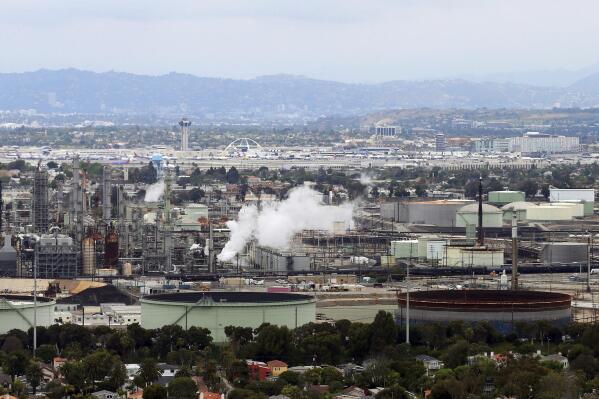 FILE - This aerial photo shows the Standard Oil Refinery in El Segundo, Calif., with Los Angeles International Airport in the background and the El Porto neighborhood of Manhattan Beach, Calif., in the foreground on May 25, 2017. A plan released by the California Air Resources Board on Tuesday, May 10, 2022, recommends a majority of the state's oil refineries install carbon capture technology by 2030. Such technology could be used to capture carbon emissions so they don't go out into the atmosphere. (AP Photo/Reed Saxon, File)