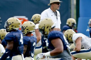 FILE - In this Aug. 9, 2018, file photo, Pittsburgh head coach Pat Narduzzi watches drills during an NCAA college football practice in Pittsburgh. Narduzzi shut down practice for a day last week when several players self-reported symptoms associated with COVID-19. All of them tested negative, but it provided an eye-opening insight into what coaching is like during a pandemic.(AP Photo/Keith Srakocic, File)