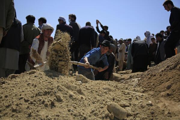 Afghan men bury a victim of deadly bombings on Saturday near a school, at a cemetery west of Kabul, Afghanistan, Sunday, May 9, 2021. The Interior Ministry said Sunday the death toll in the horrific bombing at the entrance to a girls' school in the Afghan capital has soared to some 50 people, many of them pupils between 11 and 15 years old, and the number of wounded in Saturday's attack has also climbed to more than 100. (AP Photo/Mariam Zuhaib)