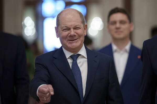 FILE - German Chancellor Olaf Scholz gestures as he arrives at the Party of European Socialists (PES) Leaders Conference, at the Palace of the Parliament, the second largest administrative building in the world after the Pentagon, in Bucharest, Romania, on April 6, 2024. Scholz arrived in China on Sunday, April 14, 2024 on a visit focused on the increasingly tense economic relationship between the sides and differences over Russia’s invasion of Ukraine. (AP Photo/Andreea Alexandru, File)