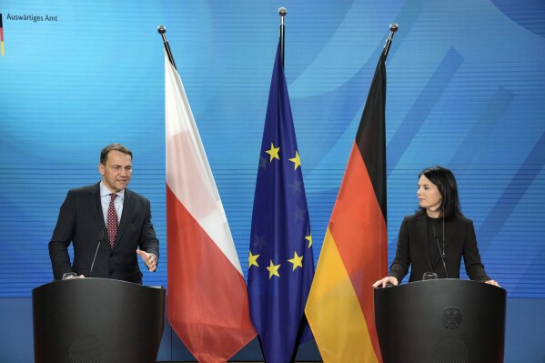 Poland Foreign Minister Radoslaw Sikorski, left, speaks during a joint press conference with his German counterpart Annalena Baerbock at the Foreign Ministry in Berlin, Tuesday, Jan. 30, 2024. (AP Photo/Ebrahim Noroozi)