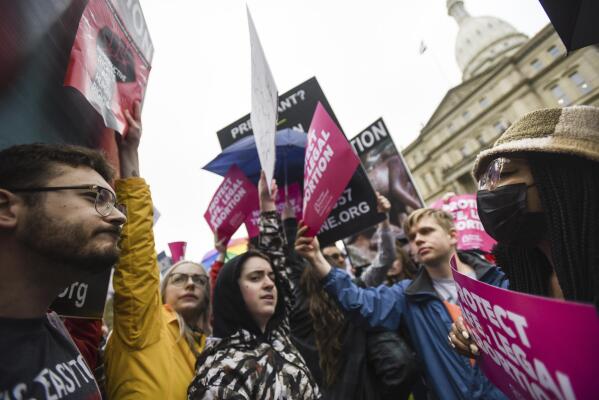 FILE - Abortion-rights advocates, right, try to block anti-abortion signage during a rally at the state capitol in Lansing, Mich., May 2, 2022, in support of abortion rights after a draft of the Supreme Court opinion was leaked in favor of overturning Roe v. Wade. (Matthew Dae Smith/Lansing State Journal via AP, File)
