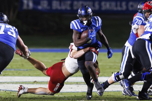 Duke's Jaquez Moore (9) is tackled by North Carolina State's Payton Wilson (11) during the first half of an NCAA college football game in Durham, N.C., Saturday, Oct. 14, 2023. (AP Photo/Ben McKeown)