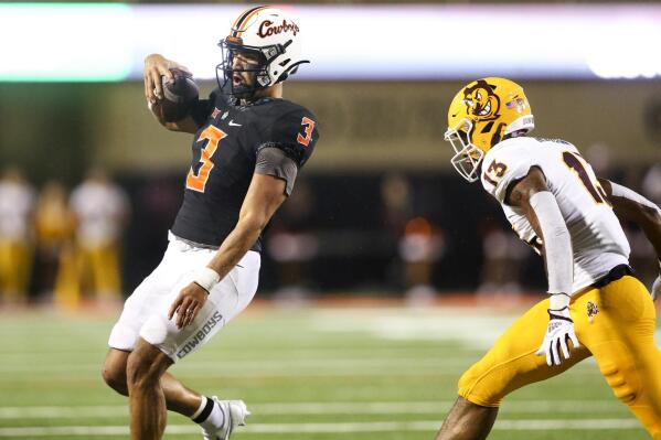 Oklahoma State quarterback Spencer Sanders (3) runs out of bounds with the ball as he is pursued by Arizona State defensive back Keon Markham (13) during an NCAA college football game Saturday, Sept. 10, 2022, in Stillwater, Okla. (Ian Maule/Tulsa World via AP)