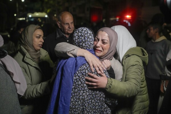 A female Palestinian prisoner, facing the camera, is greeted after her release from an Israeli prison, in the West Bank city of Beitunia, Jan. 20, 2025. (AP Photo/Leo Correa, File)