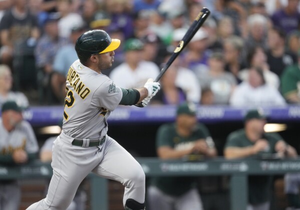 Colorado Rockies' C.J. Cron watches his RBI single off Oakland Athletics  starting pitcher Paul Blackburn during the third inning of a baseball game  Saturday, July 29, 2023, in Denver.(AP Photo/David Zalubowski Stock