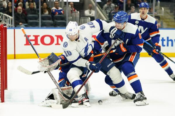 New York Islanders' Noah Dobson (8) and goaltender Ilya Sorokin protect the net from Tampa Bay Lightning's Corey Perry (10) during the first period of an NHL hockey game Sunday, March 27, 2022, in Elmont, N.Y. (AP Photo/Frank Franklin II)