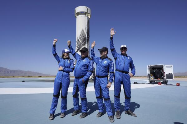 Blue Origin's New Shepard rocket latest space passengers from left, Audrey Powers, William Shatner, Chris Boshuizen, and Glen de Vries raise their hands during a media availability at the spaceport near Van Horn, Texas, Wednesday, Oct. 13, 2021. (AP Photo/LM Otero)