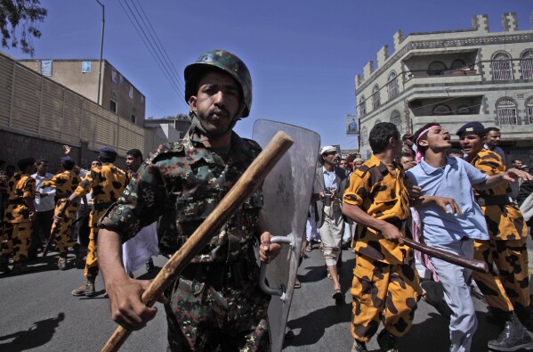 Yemeni riot police charge towards anti-government protesters during a demonstration demanding the resignation of President Ali Abdullah Saleh in Sanaa, Yemen, on Feb. 18, 2011. (AP Photo/Muhammed Muheisen, File)