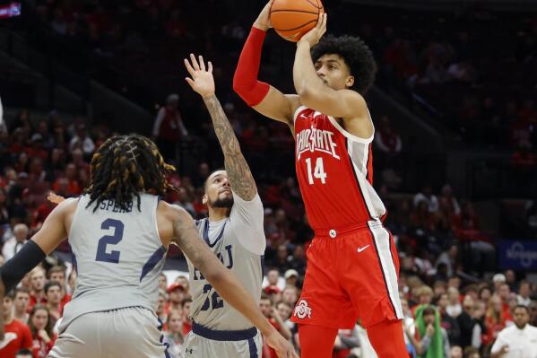 Ohio State forward Justice Sueing, right, goes up to shoot in front of Robert Morris guard Josh Corbin, center, and forward Kahliel Spear during the first half of an NCAA college basketball game in Columbus, Ohio, Monday, Nov. 7, 2022. (AP Photo/Paul Vernon)