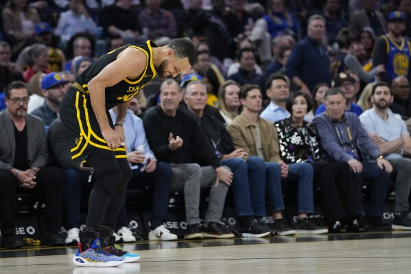 Golden State Warriors guard Stephen Curry limps off the court during the second half of the team's NBA basketball game against the Chicago Bulls, Thursday, March 7, 2024, in San Francisco. (AP Photo/Godofredo A. Vásquez)